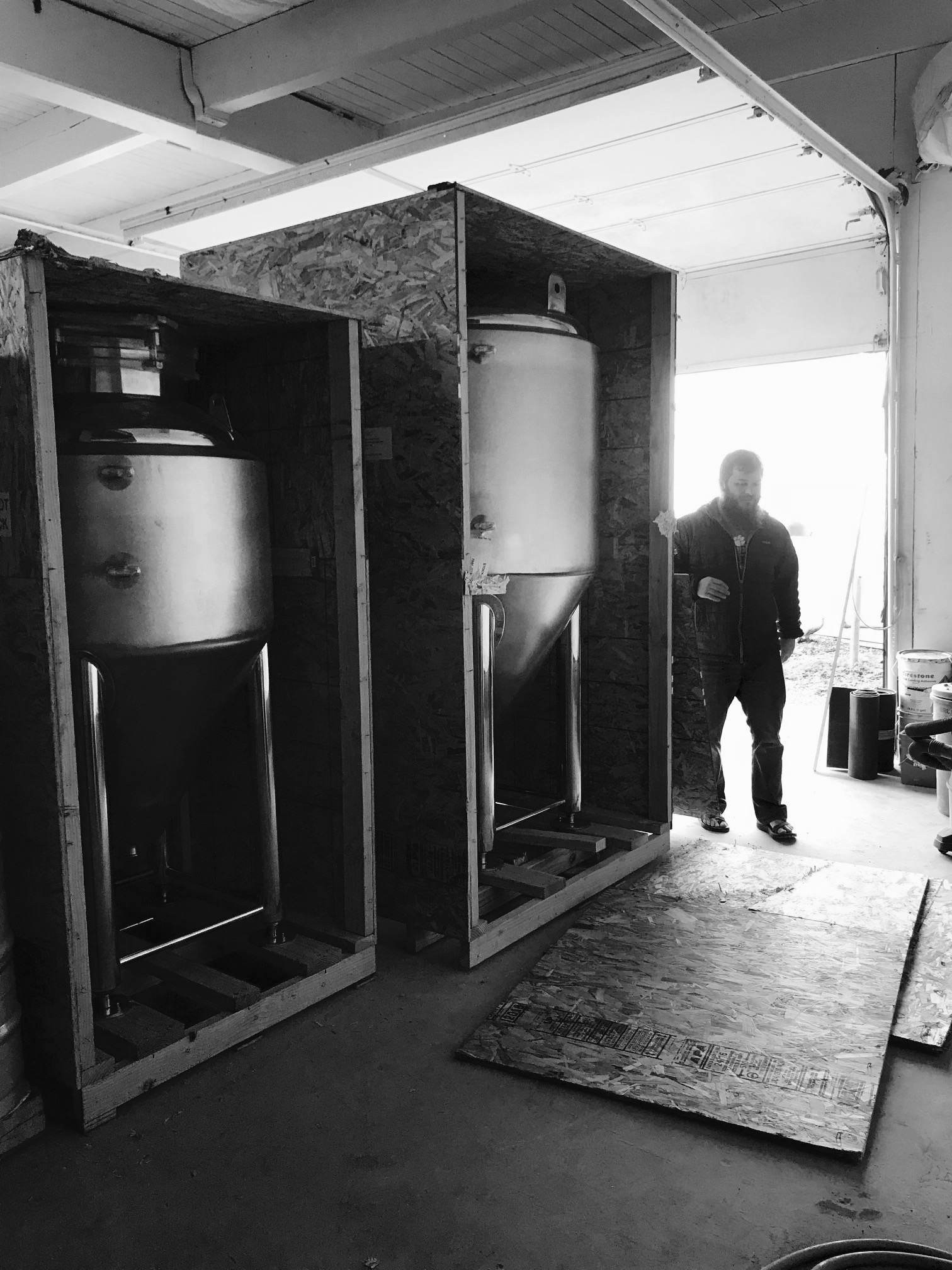 Unboxing the new fermenters at the Shattuck Way brewhouse entrance.